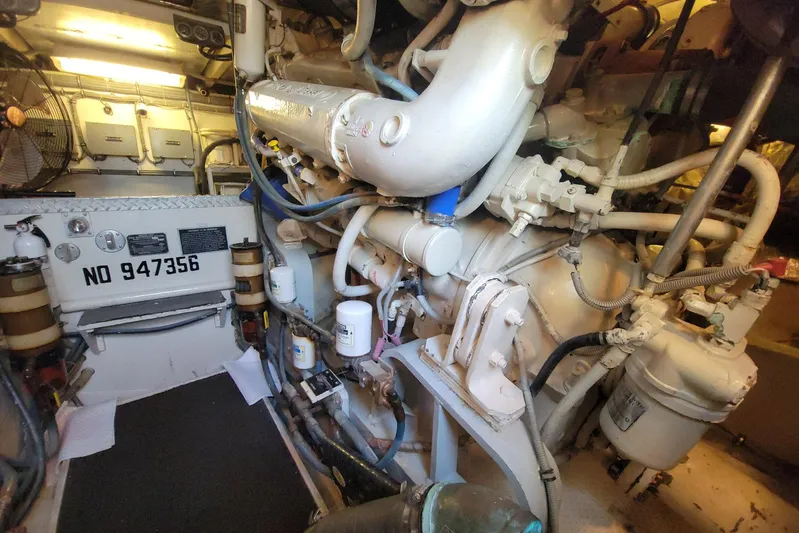 Trophy Hunter Yacht Photos Pics Engine room of a 1989 Bertram 50 Convertible yacht, showcasing complex machinery and components.