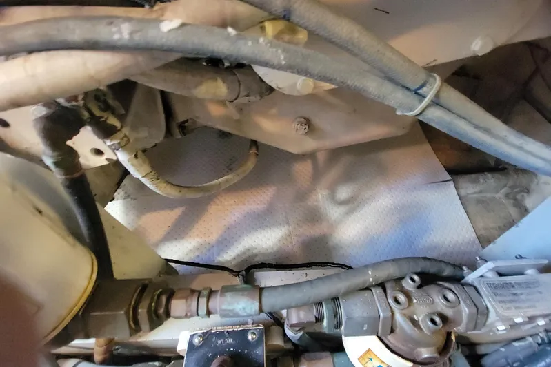 Trophy Hunter Yacht Photos Pics Engine compartment of a 1989 Bertram 50 Convertible with visible hoses and components.