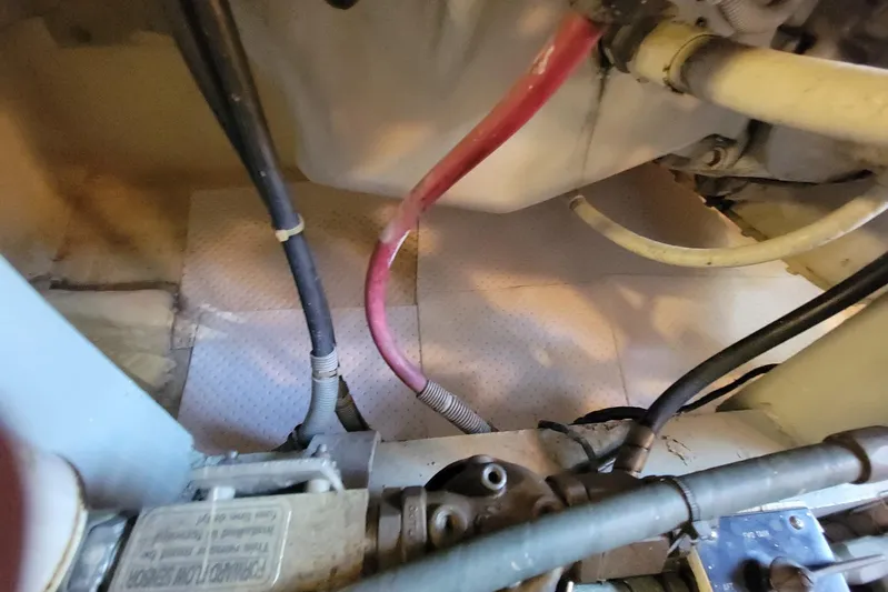 Trophy Hunter Yacht Photos Pics Engine compartment of 1989 Bertram 50 Convertible with visible hoses and components.