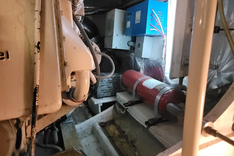 Trophy Hunter Yacht Photos Pics Engine room of a 1989 Bertram 50 Convertible with equipment and fire extinguisher.