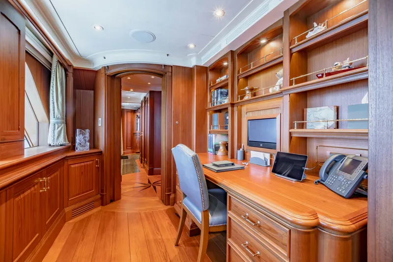 Shadowl Yacht Photos Pics Luxurious yacht office with wooden decor, desk, and shelves, featuring modern amenities.