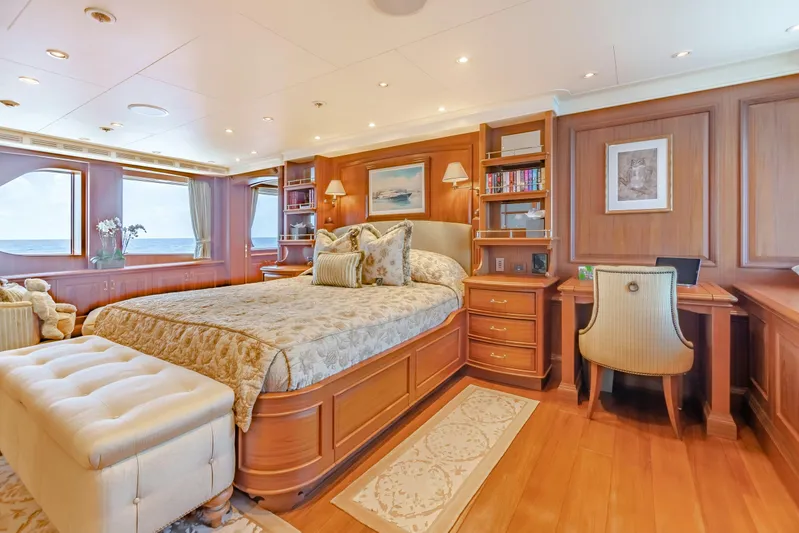 Shadowl Yacht Photos Pics Luxurious yacht bedroom with elegant wood paneling, plush bedding, and ocean view windows.