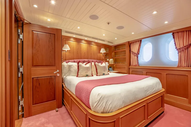 Shadowl Yacht Photos Pics Luxurious yacht bedroom with wood paneling, pink accents, and large windows, 2010 Burger Custom.