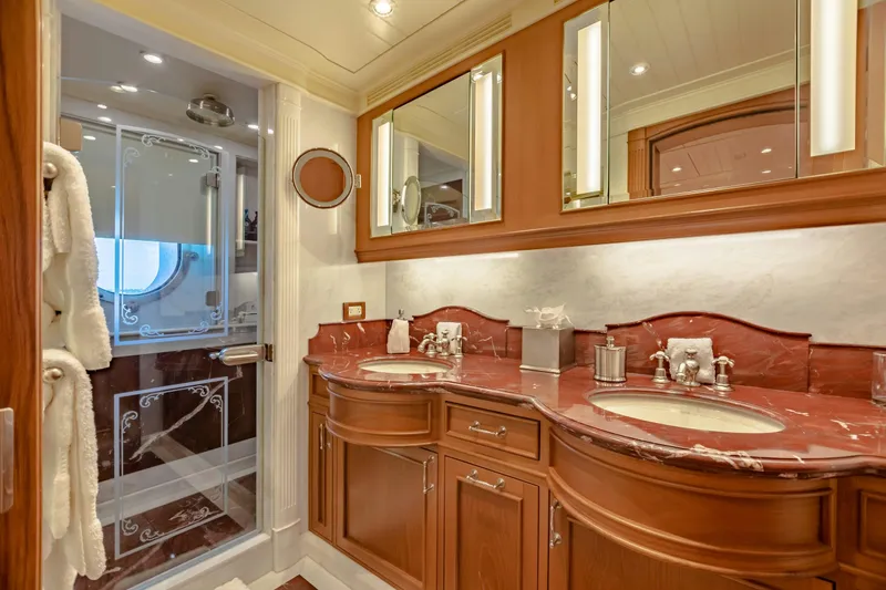 Shadowl Yacht Photos Pics Luxurious yacht bathroom with dual sinks, marble countertops, and elegant wood cabinetry.