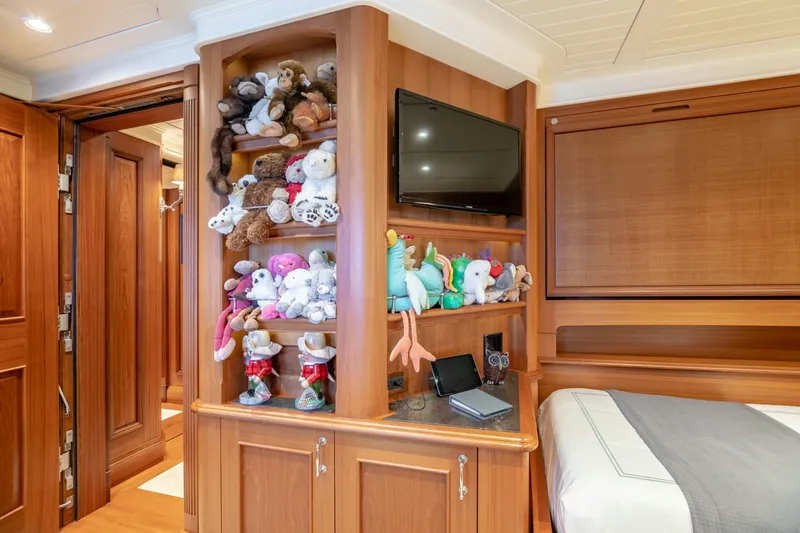 Shadowl Yacht Photos Pics Luxurious yacht cabin with plush toys, TV, and wooden cabinetry, Burger Custom 2010 model.