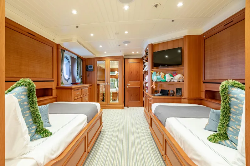 Shadowl Yacht Photos Pics Luxurious yacht cabin with twin beds, wooden decor, and modern amenities, Burger Custom 2010 model.