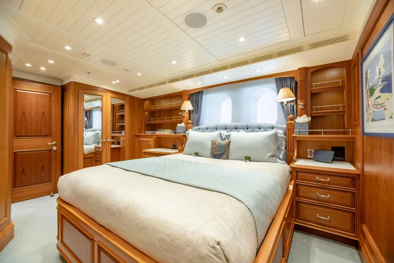 Shadowl Yacht Photos Pics Luxurious yacht bedroom with elegant wood paneling and plush bedding, Burger Custom 2010 model.