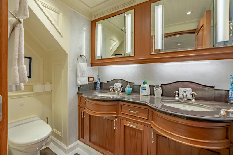 Shadowl Yacht Photos Pics Luxurious yacht bathroom with dual sinks, wooden cabinetry, and elegant lighting.
