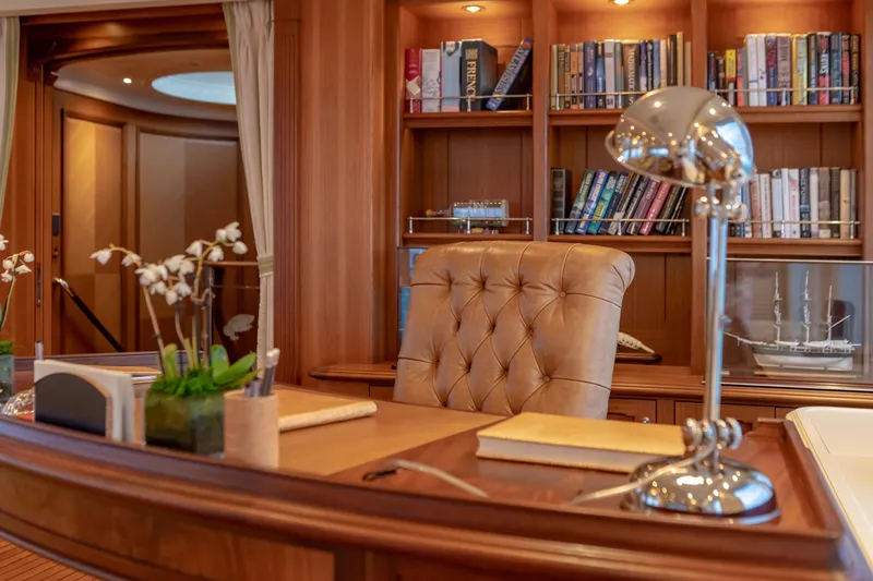 Shadowl Yacht Photos Pics Luxurious yacht office with leather chair, bookshelves, and elegant decor, aboard a 2010 Burger Custom.