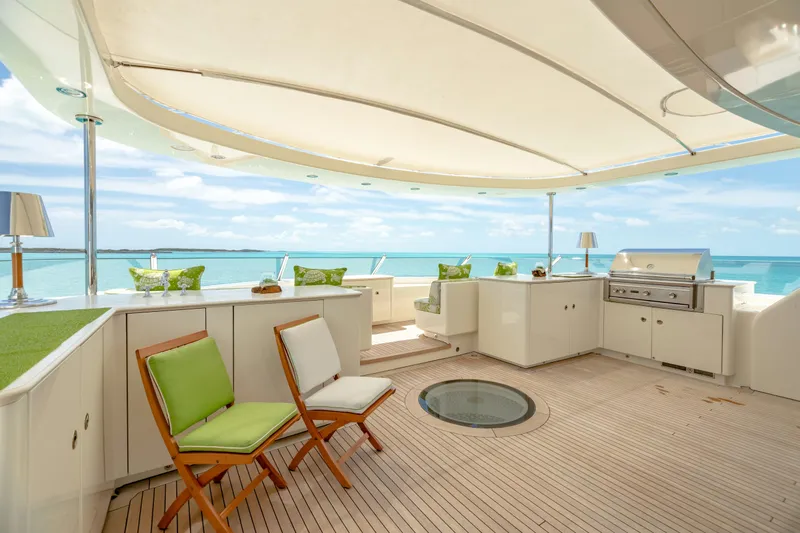 Shadowl Yacht Photos Pics Luxurious yacht deck with seating, grill, and ocean view under a canopy. Burger Custom 2010.