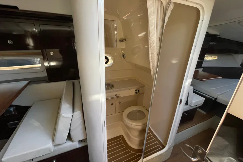  Yacht Photos Pics Interior of 2016 Sea Ray 310 Sundancer showing compact bathroom and seating area.