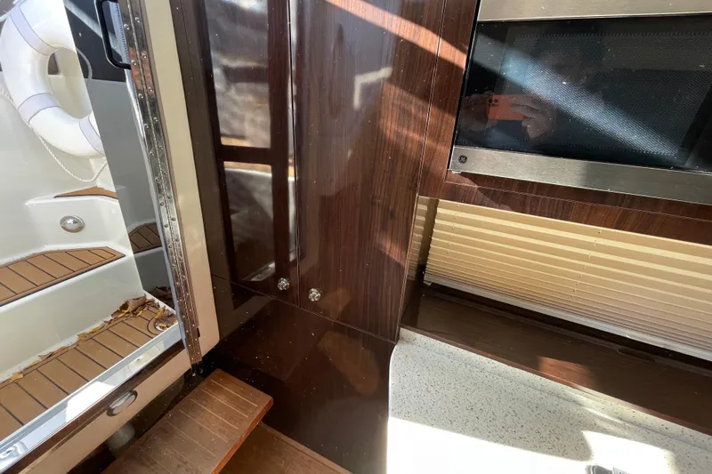  Yacht Photos Pics Interior view of 2016 Sea Ray 310 Sundancer with wood paneling and steps.