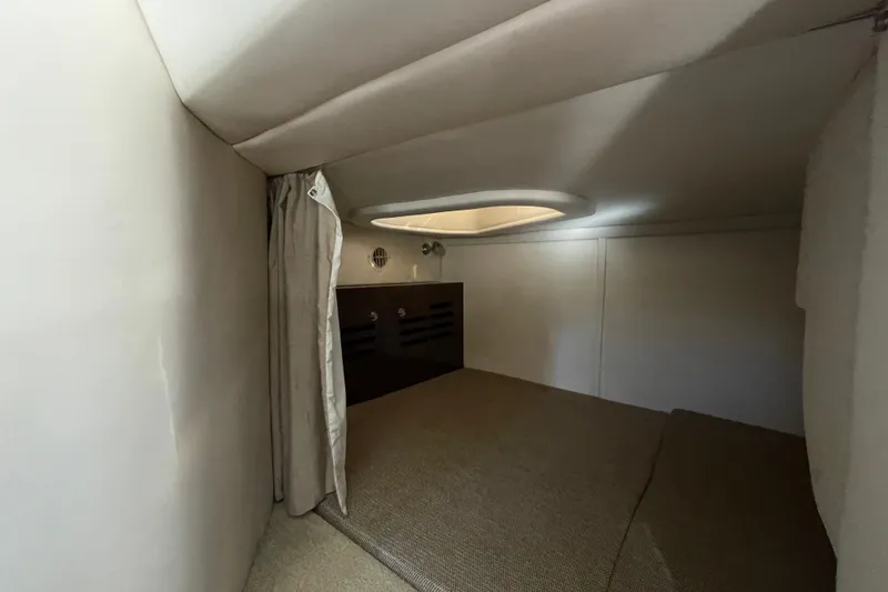  Yacht Photos Pics 2016 Sea Ray 310 Sundancer cabin interior with cozy sleeping area and curtain.