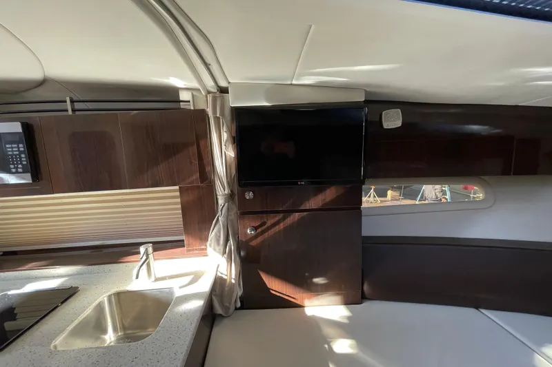 Yacht Photos Pics Interior of 2016 Sea Ray 310 Sundancer yacht with modern kitchen and TV.