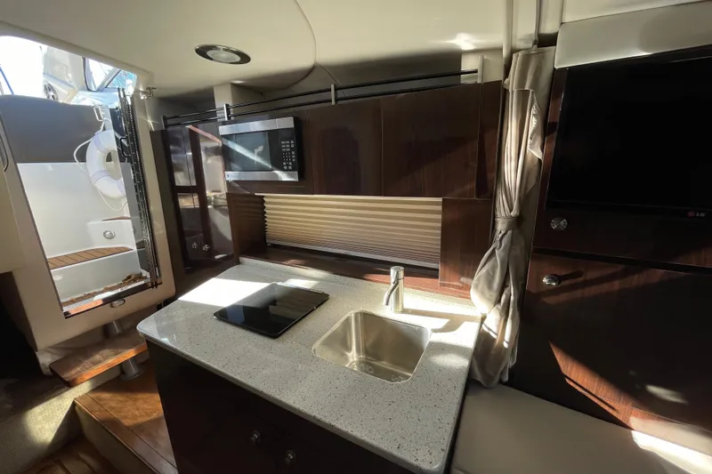  Yacht Photos Pics Interior of 2016 Sea Ray 310 Sundancer yacht with modern kitchen amenities.