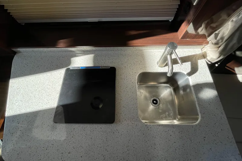  Yacht Photos Pics Compact kitchen area on 2016 Sea Ray 310 Sundancer with sink and stove.