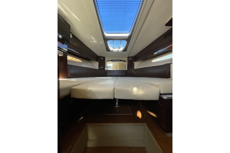  Yacht Photos Pics Interior cabin of 2016 Sea Ray 310 Sundancer with skylight and seating area.
