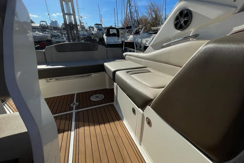  Yacht Photos Pics 2016 Sea Ray 310 Sundancer interior with cushioned seating and wooden flooring.