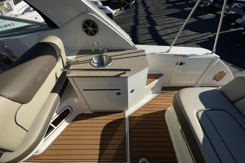  Yacht Photos Pics Luxurious 2016 Sea Ray 310 Sundancer boat interior with sink and seating area.
