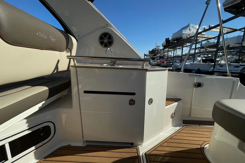  Yacht Photos Pics 2016 Sea Ray 310 Sundancer interior with seating and kitchenette, docked at marina.