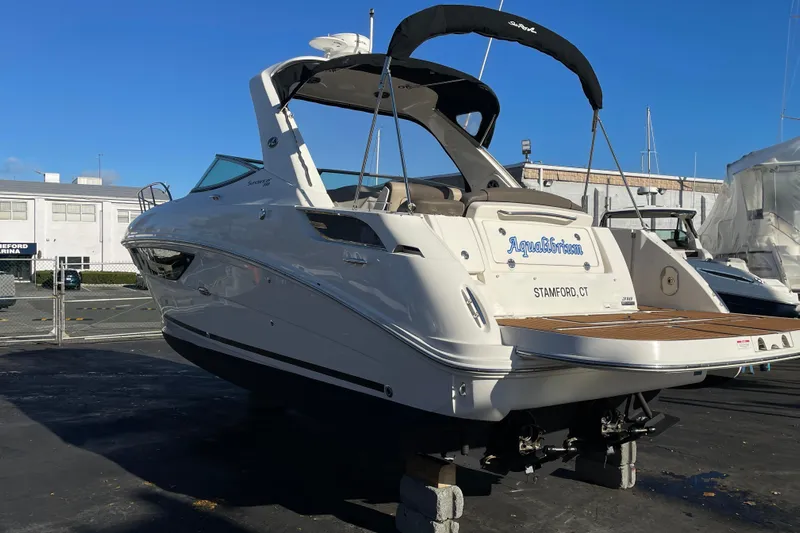  Yacht Photos Pics 2016 Sea Ray 310 Sundancer boat on display at a marina.