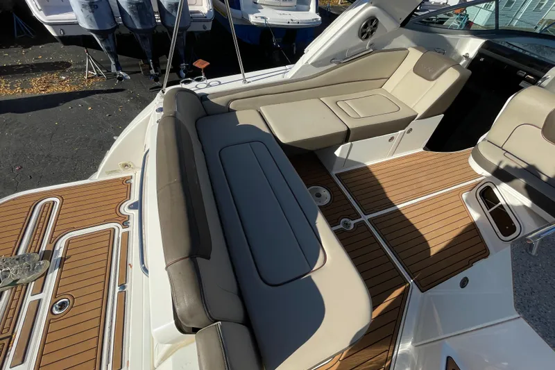  Yacht Photos Pics 2016 Sea Ray 310 Sundancer boat interior with cushioned seating and teak flooring.