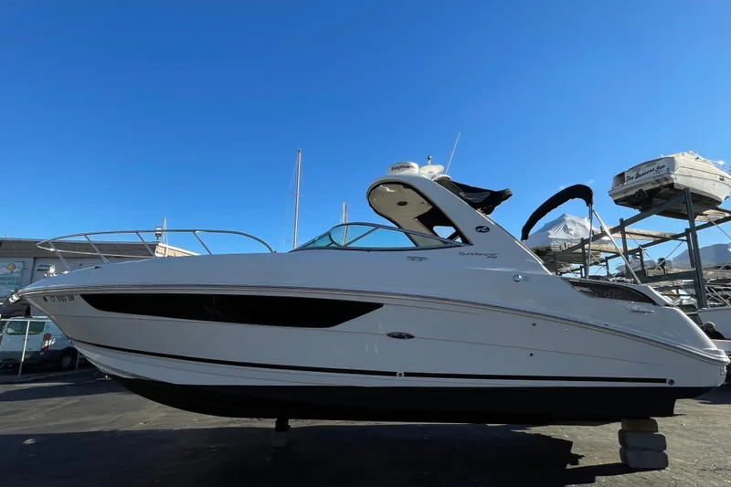  Yacht Photos Pics 2016 Sea Ray 310 Sundancer boat on display under clear blue sky.