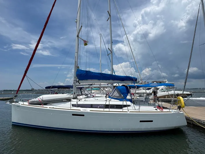 Layover Yacht Photos Pics 2018 Jeanneau Sun Odyssey 389 sailboat docked under a cloudy sky.