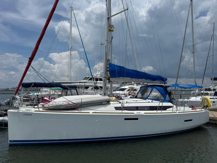 Layover Yacht Photos Pics 2018 Jeanneau Sun Odyssey 389 sailboat docked under cloudy skies.