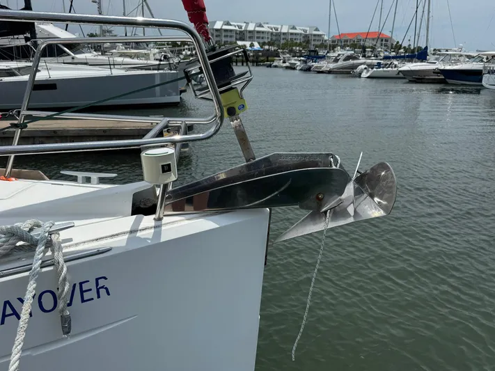 Layover Yacht Photos Pics 2018 Jeanneau Sun Odyssey 389 sailboat anchored at marina, featuring stainless steel anchor.