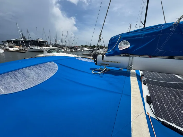 Layover Yacht Photos Pics 2018 Jeanneau Sun Odyssey 389 sailboat with blue cover in marina.
