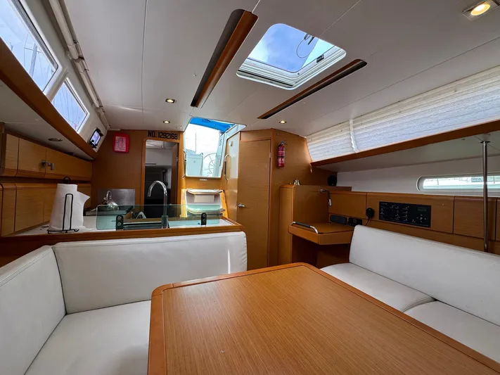 Layover Yacht Photos Pics Interior of 2018 Jeanneau Sun Odyssey 389 yacht, featuring modern kitchen and seating area.