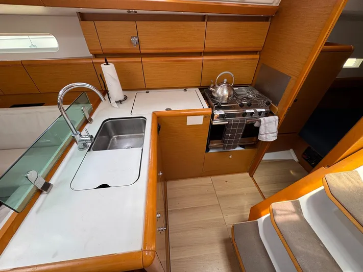 Layover Yacht Photos Pics Interior of 2018 Jeanneau Sun Odyssey 389 yacht kitchen with sink and stove.