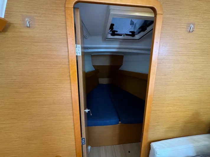 Layover Yacht Photos Pics Interior cabin of 2018 Jeanneau Sun Odyssey 389 sailboat with wooden finish.
