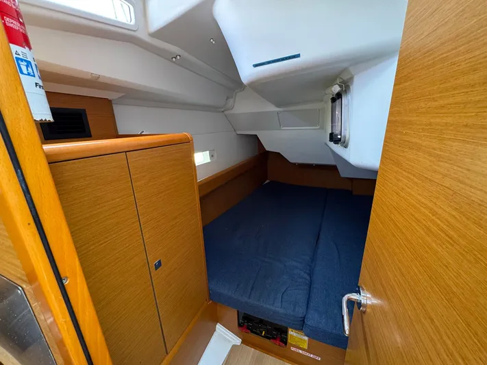 Layover Yacht Photos Pics Cozy cabin interior of 2018 Jeanneau Sun Odyssey 389 sailboat with wooden finish.