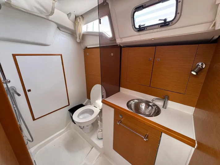Layover Yacht Photos Pics Bathroom interior of 2018 Jeanneau Sun Odyssey 389 yacht, featuring sink, toilet, and shower.