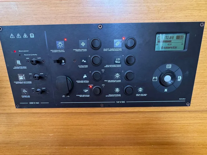 Layover Yacht Photos Pics Control panel of 2018 Jeanneau Sun Odyssey 389 yacht, featuring various switches and display.