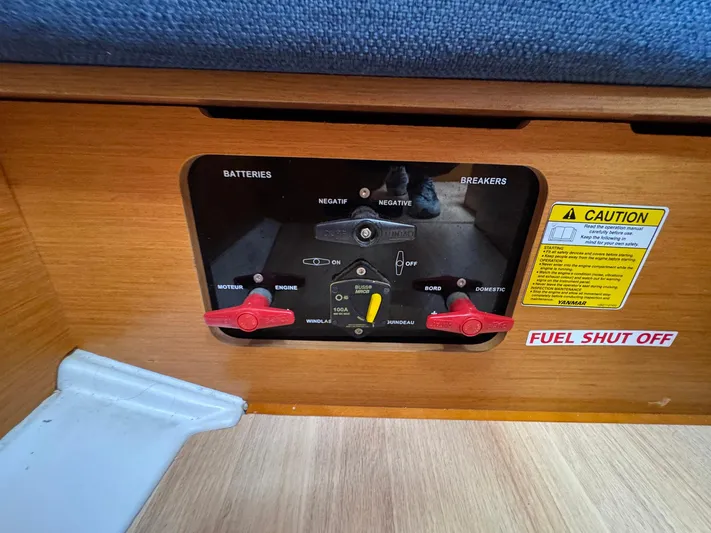 Layover Yacht Photos Pics Control panel of a 2018 Jeanneau Sun Odyssey 389 sailboat with battery switches and caution label.