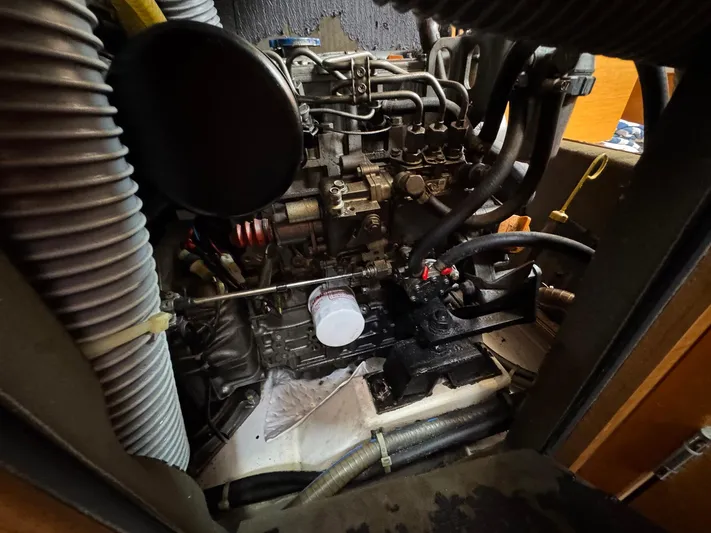 Layover Yacht Photos Pics Engine compartment of 2018 Jeanneau Sun Odyssey 389 sailboat, showcasing mechanical components and hoses.