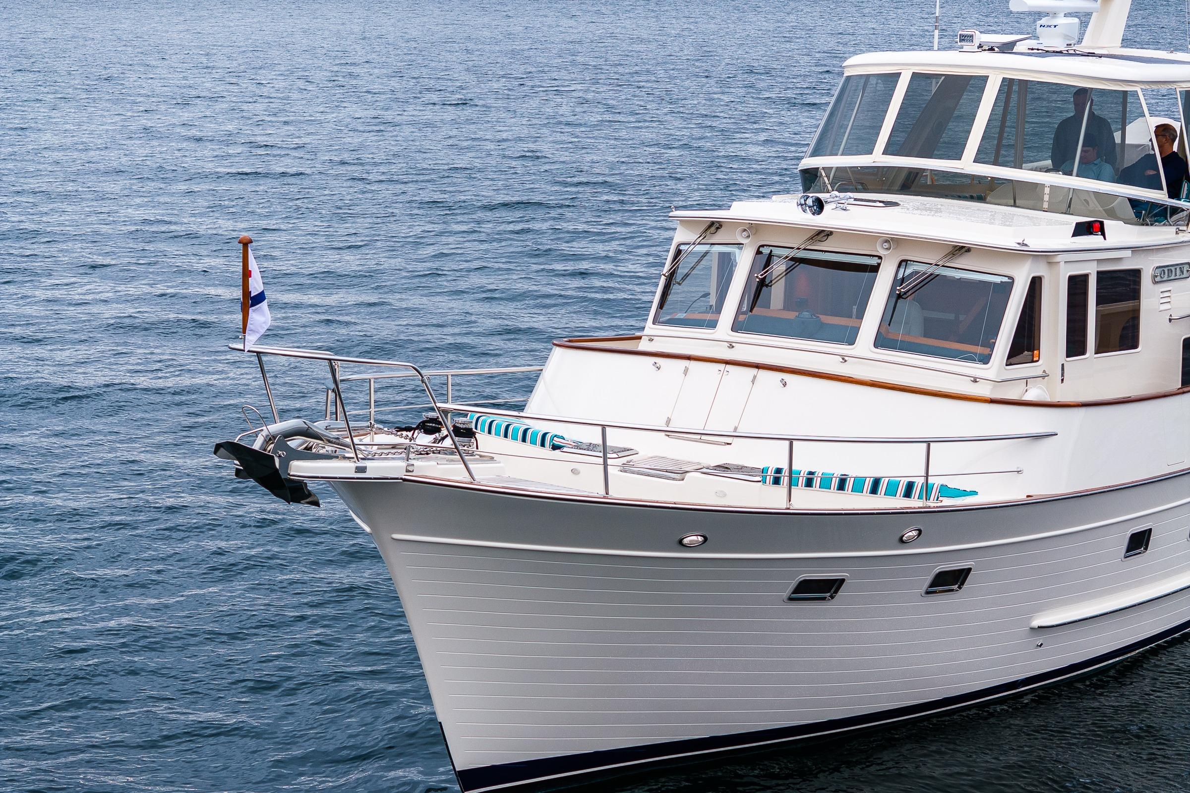 2026 Fleming 55 Pilothouse yacht cruising on calm blue waters.