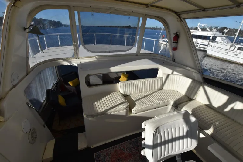 My Love Yacht Photos Pics 1993 Ocean Yachts 44 Aft Cabin interior with white seating, overlooking marina.