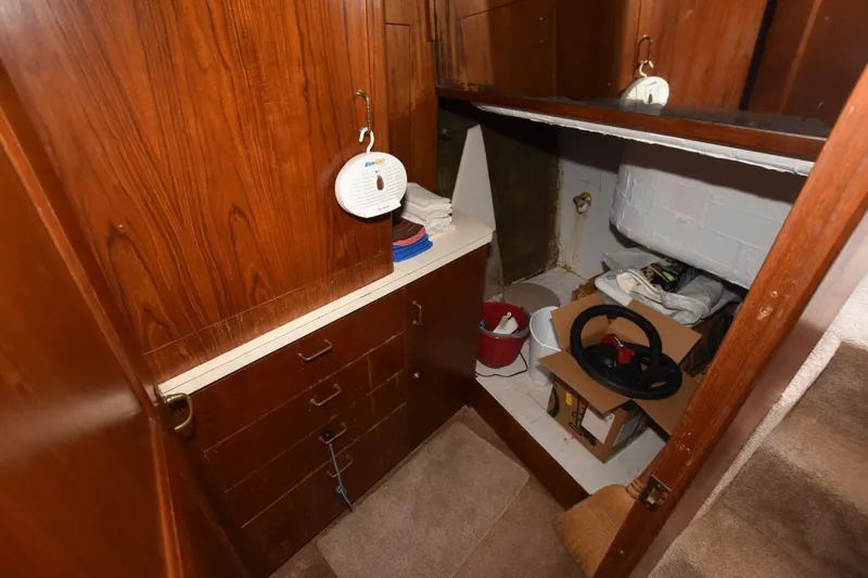 My Love Yacht Photos Pics 1993 Ocean Yachts 44 Aft Cabin interior storage area with wooden cabinets and miscellaneous items.