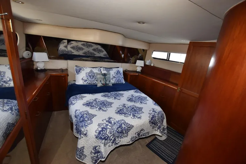 My Love Yacht Photos Pics Luxurious 1993 Ocean Yachts 44 Aft Cabin bedroom with elegant bedding and wood cabinetry.