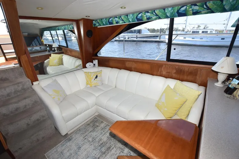 My Love Yacht Photos Pics Luxurious 1993 Ocean Yachts 44 Aft Cabin interior with white leather seating and nautical decor.