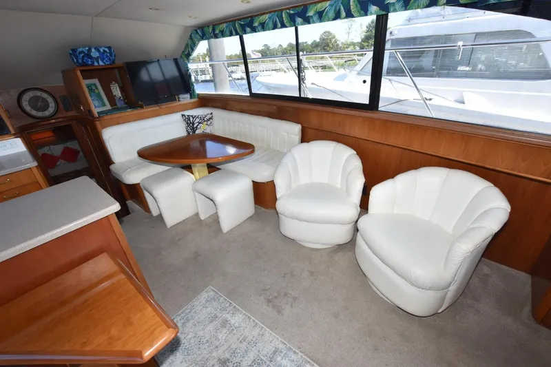My Love Yacht Photos Pics Luxurious 1993 Ocean Yachts 44 Aft Cabin interior with white seating and wooden accents.