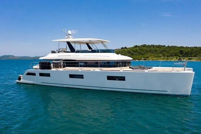  Yacht Photos Pics 2019 Lagoon 630 Motor Yacht cruising on serene blue waters.