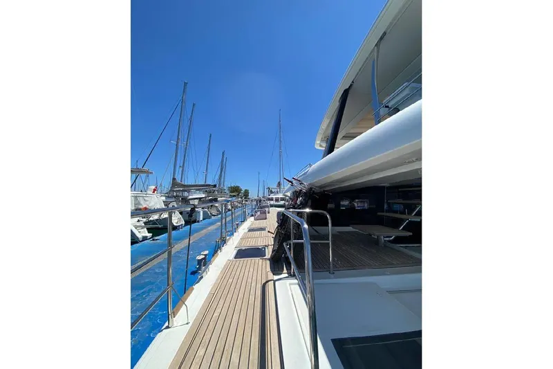  Yacht Photos Pics 2019 Lagoon 630 Motor Yacht docked, showcasing sleek design and spacious deck.