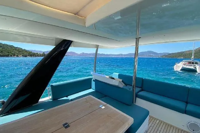  Yacht Photos Pics Luxurious Lagoon 630 Motor Yacht 2019 with scenic ocean view and comfortable seating.