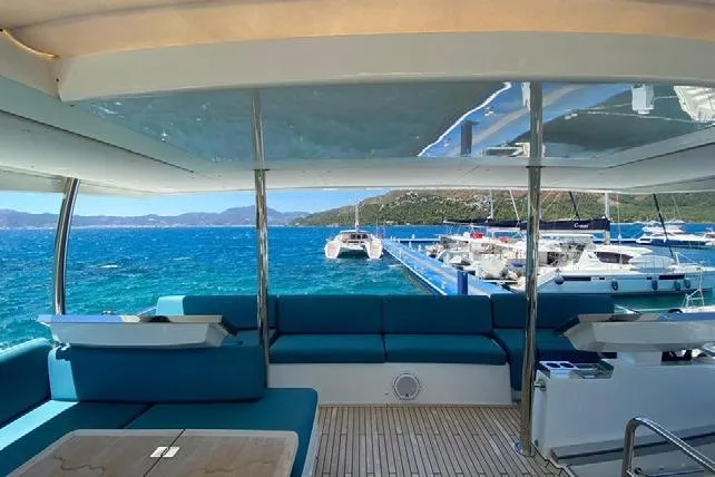  Yacht Photos Pics Luxurious 2019 Lagoon 630 Motor Yacht interior with stunning ocean view and marina backdrop.