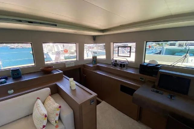  Yacht Photos Pics Interior of 2019 Lagoon 630 Motor Yacht with modern furnishings and panoramic windows.